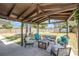 Outdoor patio featuring a wood pergola, concrete flooring, and several chairs at 6801 16Th N St, St Petersburg, FL 33702