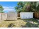 Outdoor storage sheds in backyard surrounded by wooden fences and plenty of greenery at 6801 16Th N St, St Petersburg, FL 33702