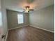 Well-lit bedroom features a ceiling fan, window, and stylish wood-look flooring at 13344 Great Plains S Dr, Riverview, FL 33579