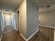 Hallway features wood-look flooring, neutral paint, and doors leading to various rooms at 13344 Great Plains S Dr, Riverview, FL 33579