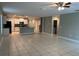 Open floor plan featuring a kitchen island with granite countertops and white cabinetry at 13344 Great Plains S Dr, Riverview, FL 33579