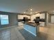 The kitchen featuring granite counters, white cabinets, and a black appliance package at 13344 Great Plains S Dr, Riverview, FL 33579