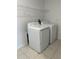 Laundry room with a washer, dryer, tile flooring, and wire shelving at 13344 Great Plains S Dr, Riverview, FL 33579