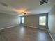 Open living room with hardwood-style floors, a ceiling fan, and bright natural light at 13344 Great Plains S Dr, Riverview, FL 33579