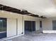 Damaged patio with missing ceiling tiles, a fan, sliding glass doors, and an exit door at 3360 Peace River Dr, Punta Gorda, FL 33983