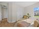 Bright bedroom featuring natural light, wood-look floors, and white closet doors at 5163 Arley Ct, North Port, FL 34288
