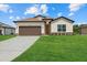 Charming single-story home featuring a well-manicured lawn and a two-car garage with brown doors at 5163 Arley Ct, North Port, FL 34288