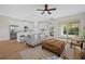 Comfortable living area with a gray sofa, woven coffee table, and easy access to the modern kitchen at 5163 Arley Ct, North Port, FL 34288