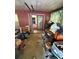 Back porch of the house with trash and debris with doors that lead into the house at 8731 N 26Th St, Tampa, FL 33604