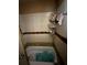 Bathroom featuring a tub with tiled walls; repairs and cleaning are needed at 8731 N 26Th St, Tampa, FL 33604