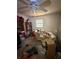 This cluttered bedroom features a ceiling fan, window, and sofa, but the room requires significant cleaning at 8731 N 26Th St, Tampa, FL 33604
