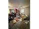 Bedroom shows a ceiling fan and vinyl floors and messy stuff at 8731 N 26Th St, Tampa, FL 33604