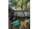 Shows a home's front exterior with trees and overgrown landscaping at 8731 N 26Th St, Tampa, FL 33604