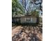 Side exterior of a home with trees and overgrown bushes at 8731 N 26Th St, Tampa, FL 33604