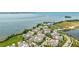 Scenic aerial view showcasing waterfront homes, tranquil bay, and beautifully landscaped community at 283 Saint Lucia Dr # 202, Bradenton, FL 34209