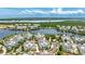 Stunning aerial view showcasing the community's tranquil lake, lush landscaping, and beautiful homes at 283 Saint Lucia Dr # 202, Bradenton, FL 34209