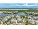 A high angle view of a neighborhood featuring beautiful homes surrounding a lake on a bright sunny day at 283 Saint Lucia Dr # 202, Bradenton, FL 34209