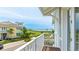 Scenic balcony view of a charming home with yellow siding, overlooking a lush green landscape and ocean at 283 Saint Lucia Dr # 202, Bradenton, FL 34209