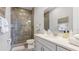Elegant bathroom featuring a glass-enclosed tiled shower, double vanity and ample counter space at 283 Saint Lucia Dr # 202, Bradenton, FL 34209