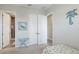 Bright bedroom with an attached bathroom featuring tiled shower, next to closet and coastal accents at 283 Saint Lucia Dr # 202, Bradenton, FL 34209