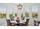 Cozy dining area with a round table, seating for six, and large windows with natural light at 283 Saint Lucia Dr # 202, Bradenton, FL 34209