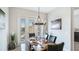Dining room with table, seating, and natural light with a view of tropical landscaping from the rear patio at 283 Saint Lucia Dr # 202, Bradenton, FL 34209