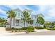 Charming two-story home featuring light blue siding, manicured landscaping, and a welcoming front porch and a palm tree at 283 Saint Lucia Dr # 202, Bradenton, FL 34209