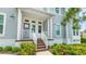 Charming home featuring a cozy front porch with light blue siding and manicured landscaping at 283 Saint Lucia Dr # 202, Bradenton, FL 34209