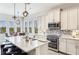 Bright kitchen with an island, stainless steel appliances, pendant lighting, and barstool seating at 283 Saint Lucia Dr # 202, Bradenton, FL 34209
