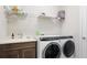 Convenient laundry room equipped with modern washer and dryer, and ample shelving at 283 Saint Lucia Dr # 202, Bradenton, FL 34209