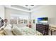 Inviting main bedroom featuring a king-size bed, tray ceiling, and a view from the window at 283 Saint Lucia Dr # 202, Bradenton, FL 34209