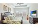 Inviting main bedroom featuring a king-size bed, tray ceiling, and a beautiful view from the window at 283 Saint Lucia Dr # 202, Bradenton, FL 34209