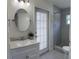 Bathroom featuring a vanity, framed mirror, and a tiled walk-in shower at 30643 Tremont Dr, Wesley Chapel, FL 33543