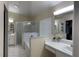 Spacious bathroom with a glass-enclosed shower, soaking tub, and dual vanities at 30643 Tremont Dr, Wesley Chapel, FL 33543