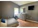 Cozy bedroom features a large window, dresser, and soothing gray walls at 30643 Tremont Dr, Wesley Chapel, FL 33543