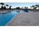A beautifully landscaped community pool with a shallow end, zero entry, and lifeguard stand at 30643 Tremont Dr, Wesley Chapel, FL 33543