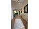 Bright entryway featuring wood floors, a decorative mirror, and an open floor plan at 30643 Tremont Dr, Wesley Chapel, FL 33543