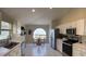 Bright eat-in kitchen boasts white cabinetry, stainless steel appliances, and a unique arched window at 30643 Tremont Dr, Wesley Chapel, FL 33543