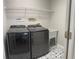 Well-lit laundry room with modern washer and dryer and decorative tile flooring at 30643 Tremont Dr, Wesley Chapel, FL 33543