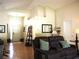 Inviting living room with hardwood floors, leather reclining sofa, and natural light at 30643 Tremont Dr, Wesley Chapel, FL 33543