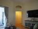 Bright living room featuring an arched doorway, hardwood floors, and sliding glass doors at 30643 Tremont Dr, Wesley Chapel, FL 33543