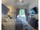 Serene main bedroom with a sliding glass door to outdoor patio and en-suite bathroom at 30643 Tremont Dr, Wesley Chapel, FL 33543