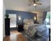 Comfortable main bedroom with a blue accent wall, stylish furnishings, and natural light at 30643 Tremont Dr, Wesley Chapel, FL 33543