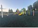 Colorful community playground with slides and climbing features on a cushioned surface at 30643 Tremont Dr, Wesley Chapel, FL 33543
