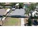 Birds eye view of home and fenced yard with patio and mature trees, with driveway at 505 Hedge Row Rd, Brandon, FL 33510