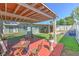 Backyard view highlighting a wooden deck, artificial grass, seating areas, and well-maintained greenery at 505 Hedge Row Rd, Brandon, FL 33510