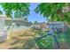 Spacious backyard featuring a covered patio area and a blue playset beneath the shade trees at 505 Hedge Row Rd, Brandon, FL 33510