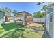 Backyard featuring a gazebo covered deck, artificial grass, shed, and a white fence at 505 Hedge Row Rd, Brandon, FL 33510