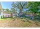 Expansive backyard with a wooden deck, artificial turf, a shed, and a swing set, perfect for outdoor enjoyment at 505 Hedge Row Rd, Brandon, FL 33510