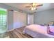 Bedroom with hard wood floors, fan, and closet for storage at 505 Hedge Row Rd, Brandon, FL 33510